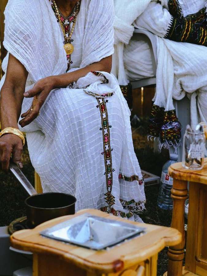 Ceremony setup with incense burner, coffee pot, and woven baskets