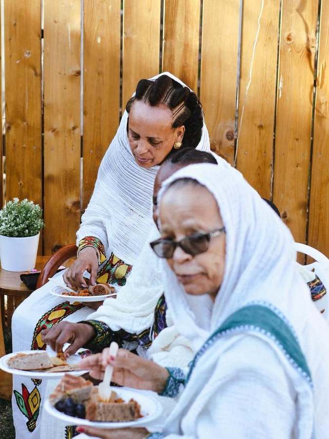 Elders sharing a plate of food together