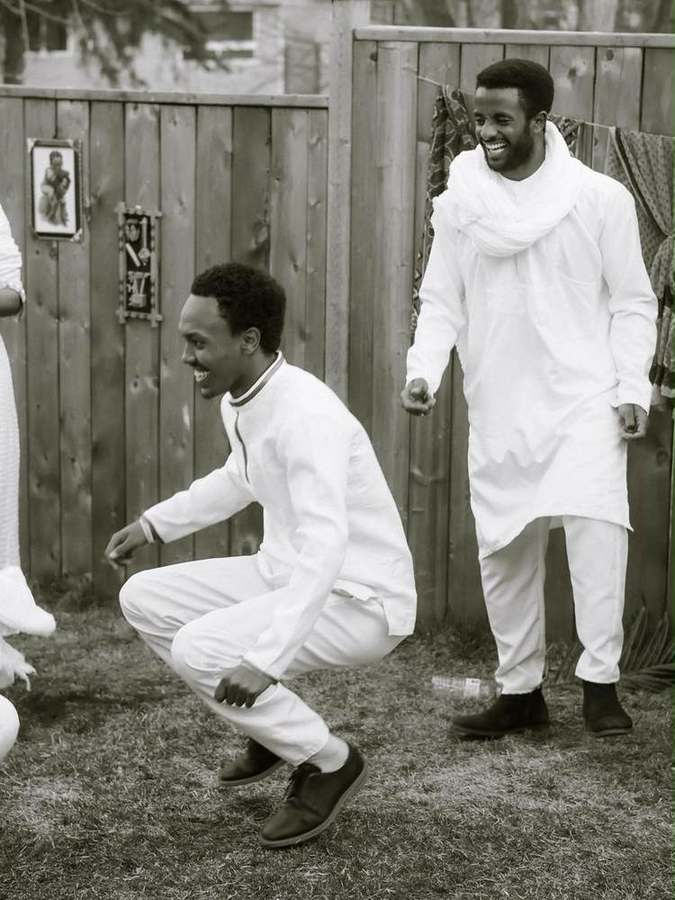 Two men laughing during a dance move