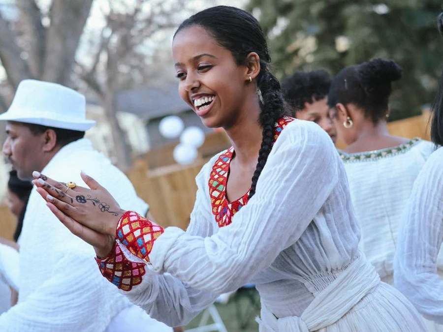 Woman clapping and smiling while dancing