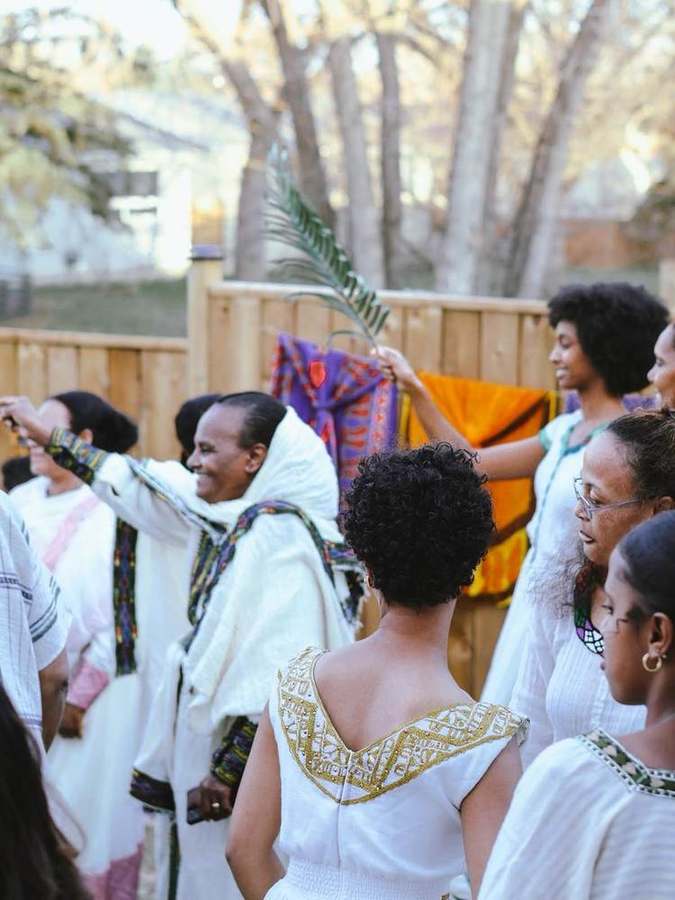 Woman raising palm branches with the group